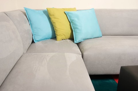 Abstract of grey suede couch & pillows