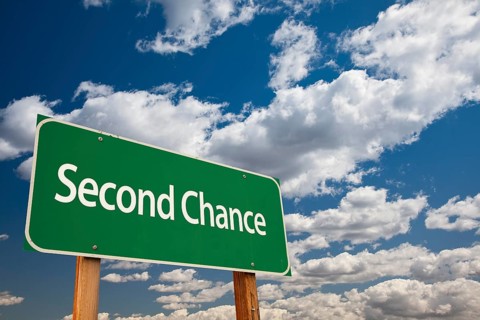 Second chance green road sign and dramatic clouds background