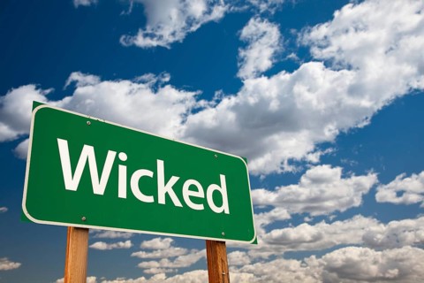 Wicked green road sign with dramatic clouds and sky