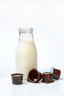 A bottle of milk and milk in portion pack