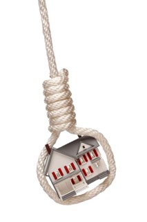House tied up and hanging in hangman's noose isolated on a white background