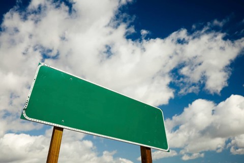 Blank road sign with dramatic clouds and sky ready for your own copy