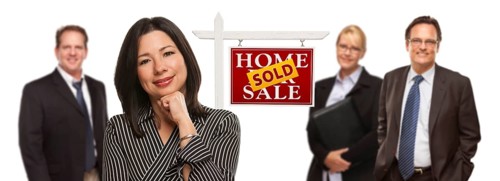 Pretty hispanic woman and other people behind in front of sold home for sale real estate sign isolated on a white background
