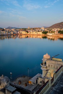 View of famous indian hinduism pilgrimage town sacred holy hindu religious city Pushkar amongst hills with Brahma mandir temple