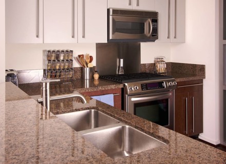 Modern apartment kitchen with brushed aluminum appliances