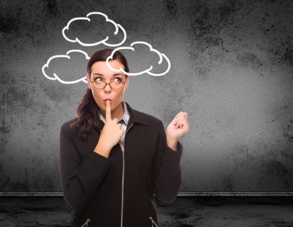 Clouds drawn around head of young adult woman in front of wall with copy space