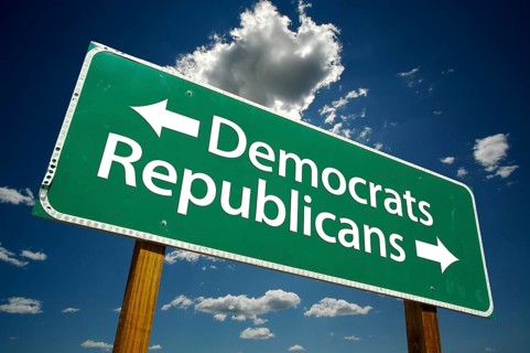 Democrats and republicans green road sign over dramatic blue sky and clouds with clipping path