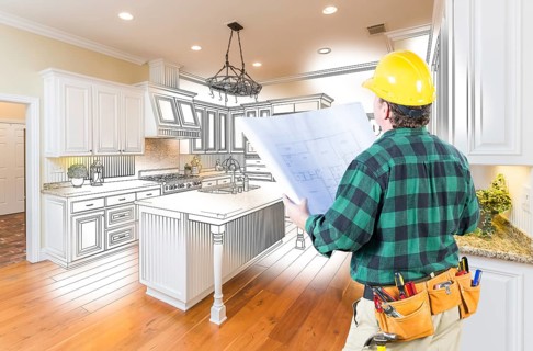 Male contractor with hard hat and plans looking at custom kitchen drawing photo combination on white