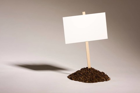 Blank white sign in mount of dirt ready for your own message