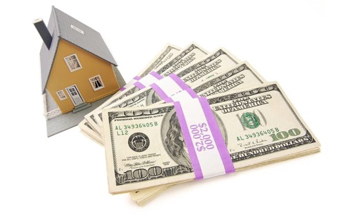 Home and stacks of money isolated on a white background