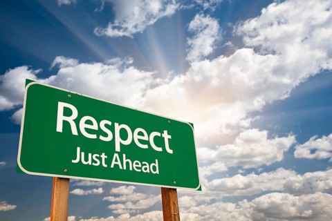Respect green road sign with dramatic clouds