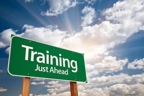 Training green road sign with dramatic clouds and sky