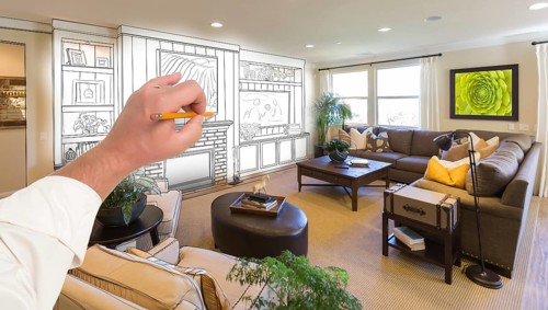 Male hand drawing entertainment center unit over photo of beautiful home interior