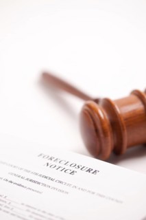 Foreclosure notice and gavel on gradated background with selective focus