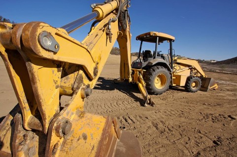 Tractor at a construction site and dirt lot