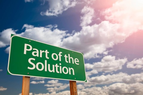 Part of the solution green road sign against sky