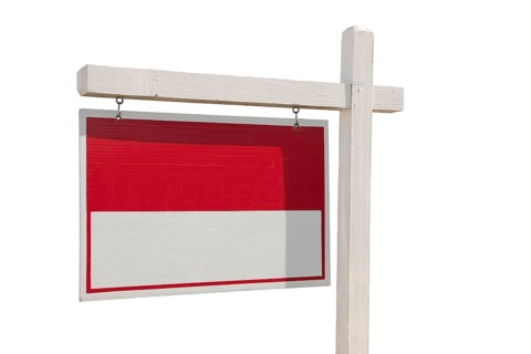 Blank real estate sign isolated on a white background ready for your own message