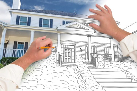 Male hands sketching with pencil the outline of a house with photo showing through