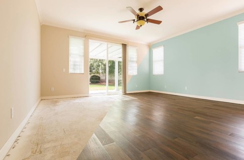 Empty room with cross section showing before and after with new wood floor and paint