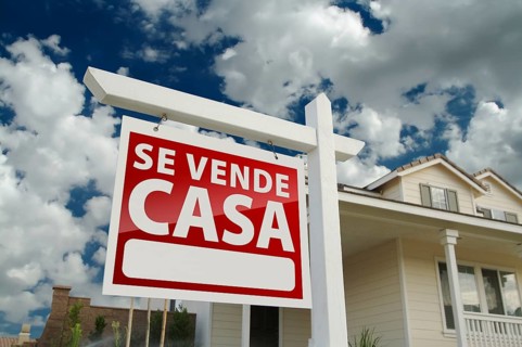 Red spanish home for real estate sale sign