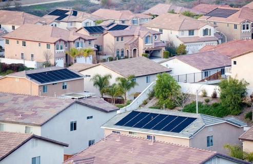 Contemporary neighborhood roof tops view with solar panels