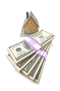 Home and stacks of money isolated on a white background
