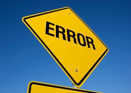 Yellow error road sign against a deep blue sky with clipping path