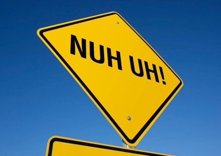 Nuh uh! yellow road sign against a deep blue sky with clipping path