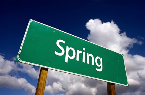 Spring road sign with dramatic clouds and sky