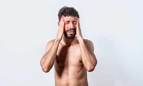 Shirtless man with headache