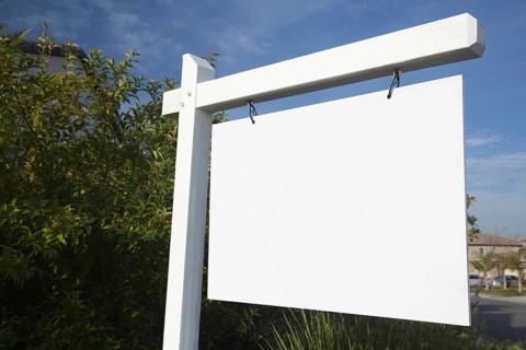 Blank real estate sign in neighborhood ready for your own message