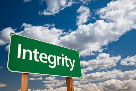 Integrity green road sign with copy room over the dramatic clouds and sky