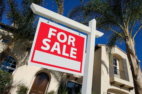Home for sale sign in front of new house