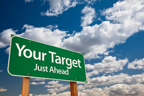 Your target green road sign over dramatic clouds and sky