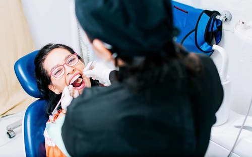 Top view of dentist doing dental checkup