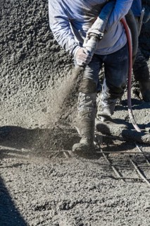 Pool construction worker shooting concrete