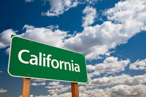 California green road sign with copy room over the dramatic clouds and sky