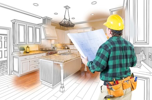Male contractor with hard hat and plans looking at custom kitchen drawing photo combination on white