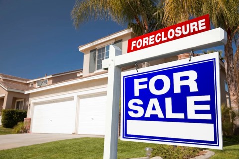 Foreclosure for sale real estate sign in front of house