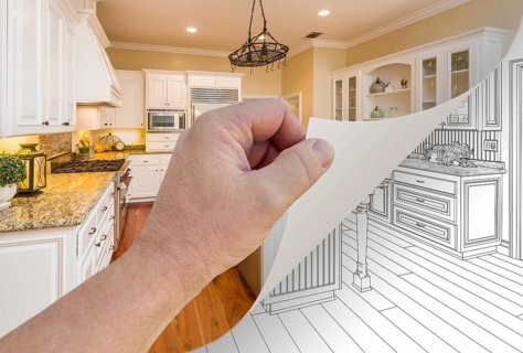 Male hand turning page of custom kitchen photograph to drawing underneath