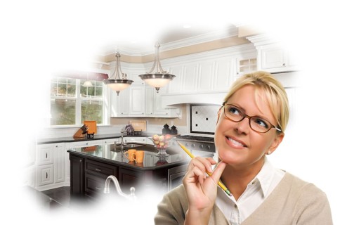 Daydreaming woman with pencil over custom kitchen photo in thought bubble