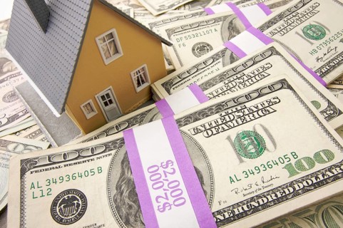Home with stacks of money as background
