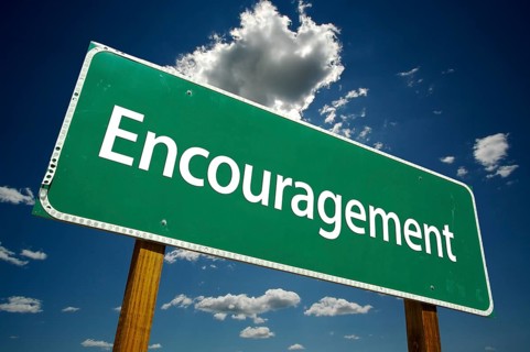 Encouragement road sign with dramatic clouds and sky