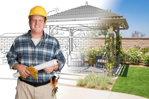 Male contractor with house plans wearing hard hat in front of custom pergola patio covering drawing photo combination