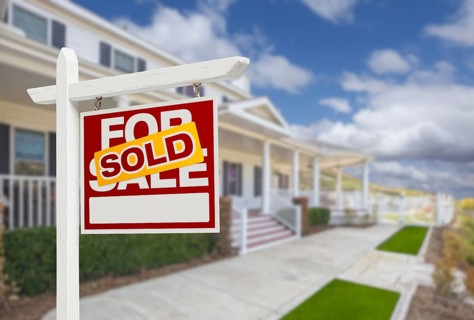 Sold home for sale real estate sign and beautiful new house