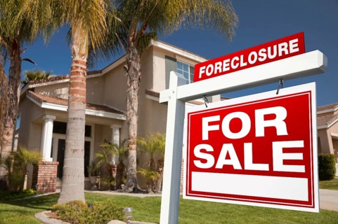 Foreclosure for sale real estate sign in front of house