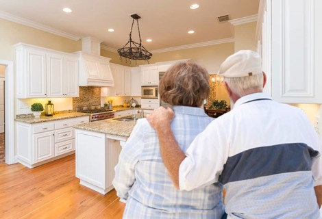 Happy senior couple looking over beautiful custom kitchen design