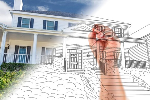 Male hand sketching with pencil the outline of a house with photo showing through