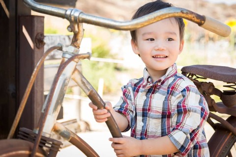 Cute mixed-race young boy having fun on the bicycle