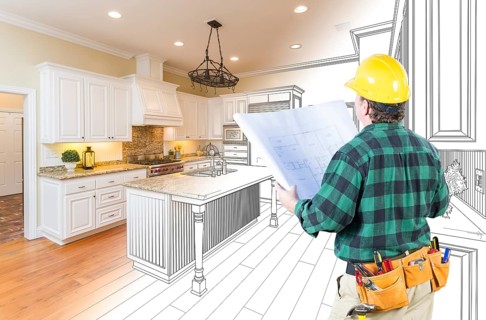 Male contractor with hard hat and plans looking at custom kitchen drawing photo combination on white